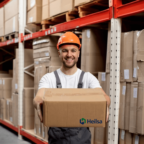 heilsa our company vision image Smiling man showing Heilsa product package at warehouse